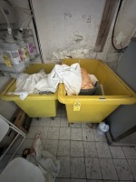 YELLOW PLASTIC ROLLING LAUNDRY TUBS WITH CONTENTS