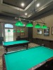 BRASS BAR HANGING LIGHTS WITH 4 LIGHTS WITH GREEN GLASS SHADES ***TO BE REMOVED BY MAINTENANCE DEPARTMENT***