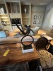 ARTWORK - CAST IRON SCULPTURE ON STONE BASE - MAN ON WHEEL