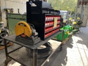 CRIMPING STATION WITH MOBILE CRIMP, VISE, PNEUMATIC FEED, DEWALT D28700 14'' CHOPSAW, METAL TABLE ON WHEELS, STORAGE CABINET & 4 SHELVES OF ASSORTED FITTINGS